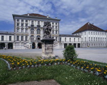 Nymphenberg Palace. Stone statue on plinth with flower bed in foreground