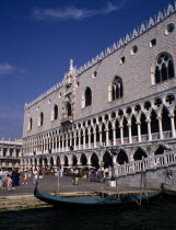 Doges Palace aka Palazzo Ducale exterior with moored gondola in the foreground