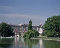 Buckingham Palace. View from Green Park with trees surrounding lake and fountains