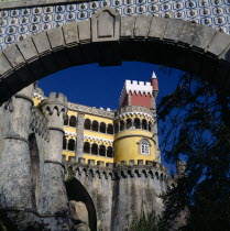 Pena Palace. View through archway to yellow and red tower with arches and crennalations