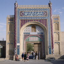 The Summer Palace. Local people at entrance gate with vivid mosaics