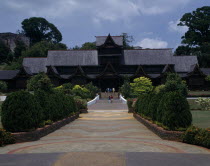 The Sultans Palace. Tourist walking along the entrance path lined with small trees