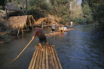 Tourists rafting through the jungle south of Chiang MaiAsian Prathet Thai Raja Anachakra Thai Siam Southeast Asia Holidaymakers Siamese Tourism