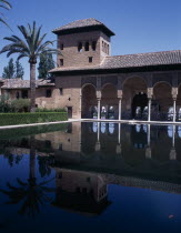 The Alhambra. Palace of the Maids general view of the tower reflected in the pond