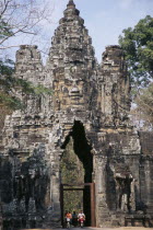 South Gate with people on mopeds driving through the openingAsian Cambodian Kampuchea Religion Southeast Asia History Kamphuchea Religious