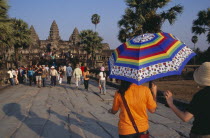 Tourists on stone causeway leading to temple complex.  Many Cambodians visiting during Chinese New Year. Asian Kampuchea Religion Southeast Asia History Holidaymakers Kamphuchea Religious Tourism