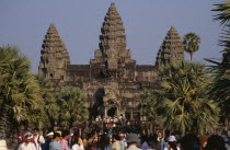 Tourists on stone causeway leading to temple complex.  Many Cambodians visiting during Chinese New Year. Asian Kampuchea Religion Southeast Asia History Holidaymakers Kamphuchea Religious Tourism