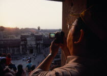 Tourist with video camera.Asian Cambodian Kampuchea Religion Southeast Asia History Holidaymakers Kamphuchea Religious Sightseeing Tourism Tourists