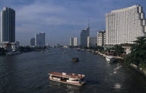 The Shangri La Hotel on the right The Peninsula Hotel on the left either side of the Chao Phraya river with a cross river ferry in the foregroundAsian Prathet Thai Raja Anachakra Thai Siam Southeast...