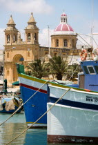 Fishing village harbour on the south coast with colourful fishing boats and the Church dedicated to Our Lady of the Rosary The Madonna of Pompeii