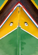 Fishing village harbour on the south coast with colourful Kajjiki fishing boat with the Eyes of Osiris on the bow