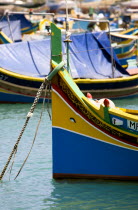 Fishing village harbour on the south coast with colourful Kajjiki fishing boats with the Eyes of Osiris on the bow