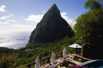 Val des Pitons Tourists sunbathing on the sun deck beside the pool at Ladera Spa Resort Hotel overlooking Petit Piton volcanic plug and Jalousie beach