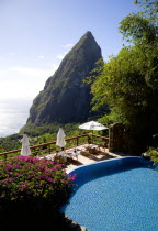 Val des Pitons Tourists sunbathing on the sun deck beside the pool at Ladera Spa Resort Hotel overlooking Petit Piton volcanic plug and Jalousie beach