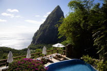 Val des Pitons Tourists sunbathing on the sun deck beside the pool at Ladera Spa Resort Hotel overlooking Petit Piton volcanic plug and Jalousie beach