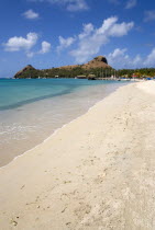 The beach at Sandals Grande St Lucian Spa and Beach Resort hotel with Pigeon Island National Historic Park beyond