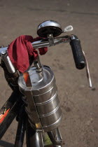 Cropped shot of bicycle with tiffin box tied to handlebars.culturetransportationvehiclebelllunchboxmeal Asia Asian Bharat Bombay Inde Indian Intiya