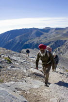 Olympus.  Group of four climbing steep slope of Mount  Olympus towards the highest peak called Mytikas. OlymposMitikasMytykasMitykas4 Ellada European Greek Scenic Southern Europe