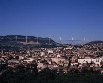 Millau.  Cityscape with Millau bridge beyond which carries the A75 motorway from Beziers to Clermont Ferrand.