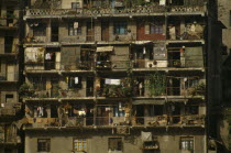 Detail of apartment blocks with washing lines and plants hanging from balconies on the banks of the River YangtsiAsia Asian Chinese Chungkuo Jhonggu Zhonggu Clean Cleaning Flat Laundry