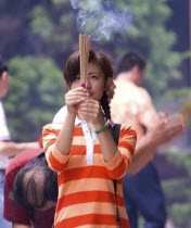 Burning incense at Puji TempleAsia Asian Chinese Chungkuo Jhonggu Zhonggu One individual Solo Lone Solitary Religious