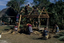 Independent Seminole Native Americans thatching a Chickee hut using palm frondsNorth America United States of America American Kids