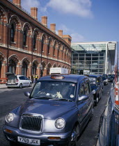 St Pancras International exterior showing both new  terminal for Eurostar trains to continental Europe and original buildings with line of waiting taxis outside.European Great Britain Londres Norther...