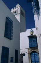 Part view of white painted mosque with decorative  blue painted balconies  window shutters and doorway.African Middle East North Africa Religion Religious