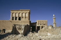 Old village houses being demolished with a minaret of a mosque beyondMoslem History Islam Middle East Muslim Qatari Religion Religion Religious Muslims Islam Islamic