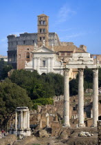 View of The Forum with the Colosseum rising behind the bell tower of the church of Santa Francesca Romana with the Temple of The Vestals and the three Corinthian columns of the Temple of Castor and Po...