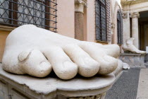 Palazzo Dei Conservatore courtyard part of the Capitoline Museums with giant marble feet from various ancient colossus statuesEuropean Italia Italian Roma Southern Europe History Learning Lessons Tea...