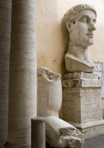 Palazzo Dei Conservatore courtyard part of the Capitoline Museums with a giant marble head and arm from an ancient 4th Century colossus statue of Emperor Constantine IEuropean Italia Italian Roma Sou...