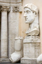 Palazzo Dei Conservatore courtyard part of the Capitoline Museums with a giant marble head and arm from an ancient 4th Century colossus statue of Emperor Constantine IEuropean Italia Italian Roma Sou...