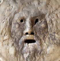 The Boca Della Verite or Mouth of Truth at the church of Santa Maria In Cosmedin. Possibly a 4th Century drain cover it is set into the wall of the portico and Medieval tradition had it that the mouth...