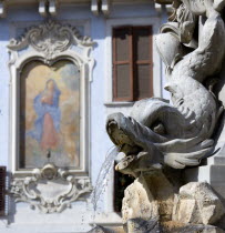 Detail of a dolphin on the Fountain of Piazza Della Rotonda by Giacomo Della Porta in 1575 with a religious fresco on the wall of a building beyondEuropean Italia Italian Roma Southern Europe History...