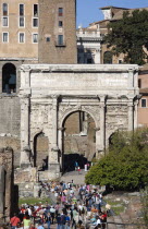 Tourists walking towards the triumphal Arch of Septimius Severus in the ForumEuropean Italia Italian Roma Southern Europe History Holidaymakers Tourism