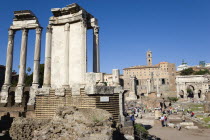 The Forum with tourists. The Temple of The Vestals on the left and the Arch of Septimius Severus on the rightEuropean Italia Italian Roma Southern Europe History Holidaymakers Tourism