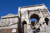 Tourists walking through the triumphal Arch of Septimius Severus in the ForumEuropean Italia Italian Roma Southern Europe History Holidaymakers Tourism