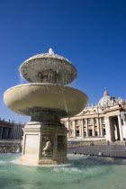 Vatican City The Basilica of St Peter and the square or Piazza San Pietro with tourists and a water fountain in the foregroundEuropean Italia Italian Roma Southern Europe Catholic Principality Citta...