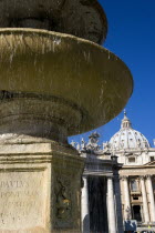 Vatican City The Basilica of St Peter and the square or Piazza San Pietro with tourists and a water fountain in the foregroundEuropean Italia Italian Roma Southern Europe Catholic Principality Citta...