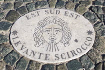 Vatican City Plaque in the pavement of Piazza San Pietro or St Peters Square depicting the East South East wind know as the Levante SciroccoEuropean Italia Italian Roma Southern Europe Catholic Princ...