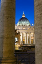 Vatican City The Basilica of St Peter and the square or Piazza San Pietro illuminated at night seen through the columns of BerniniEuropean Italia Italian Roma Southern Europe Catholic Principality Ci...