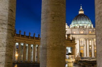 Vatican City The Basilica of St Peter and the square or Piazza San Pietro illuminated at night seen through the columns of BerniniEuropean Italia Italian Roma Southern Europe Catholic Principality Ci...