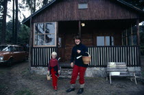 Rural home with young woman and child standing outside.house housing residential country Ceska Children Eastern Europe European Female Women Girl Lady Immature Kids