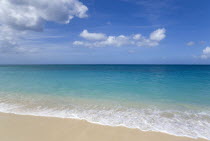 Waves breaking on the shore at Grand Anse Beach with the turquoise sea beyondBeaches Resort Sand Sandy Scenic Seaside Shore Tourism West Indies Caribbean Grenadian Greneda