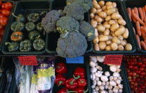 Vegetables in trays outside greengrocers shop.European Great Britain UK United Kingdom British Isles Northern Europe Store