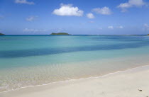 The calm clear blue water breaking on Paradise Beach in LEsterre Bay with Sandy Island in the distanceCaribbean Grenadian Greneda West Indies Grenada Beaches Resort Scenic Seaside Shore Tourism