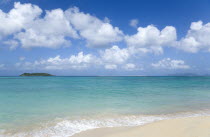 The calm clear blue water breaking on Paradise Beach in LEsterre Bay with Mabouya Island and Sandy Island in the distanceCaribbean Grenadian Greneda West Indies Grenada Beaches Resort Scenic Seaside...