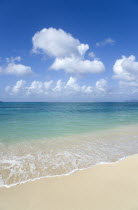 The calm clear blue water breaking on Paradise Beach in LEsterre Bay with Sandy Island in the distanceCaribbean Grenadian Greneda West Indies Grenada Beaches Resort Scenic Seaside Shore Tourism