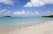 The calm clear blue water breaking on Paradise Beach in LEsterre Bay with Mabouya Island and Sandy Island in the distanceCaribbean Grenadian Greneda West Indies Grenada Beaches Resort Scenic Seaside...